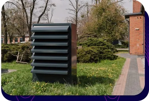 Nowoczesna, stylowa obudowa na pompę ciepła, idealnie wkomponowana w zadbany ogród przy domu jednorodzinnym.